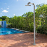 Stainless steel outdoor shower installed near a pool, surrounded by trees and wooden decking.