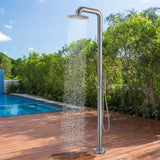 Stainless steel outdoor shower in use, water flowing from the overhead shower head by the pool.