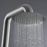 Close-up of the stainless steel shower head with water jets spraying evenly.